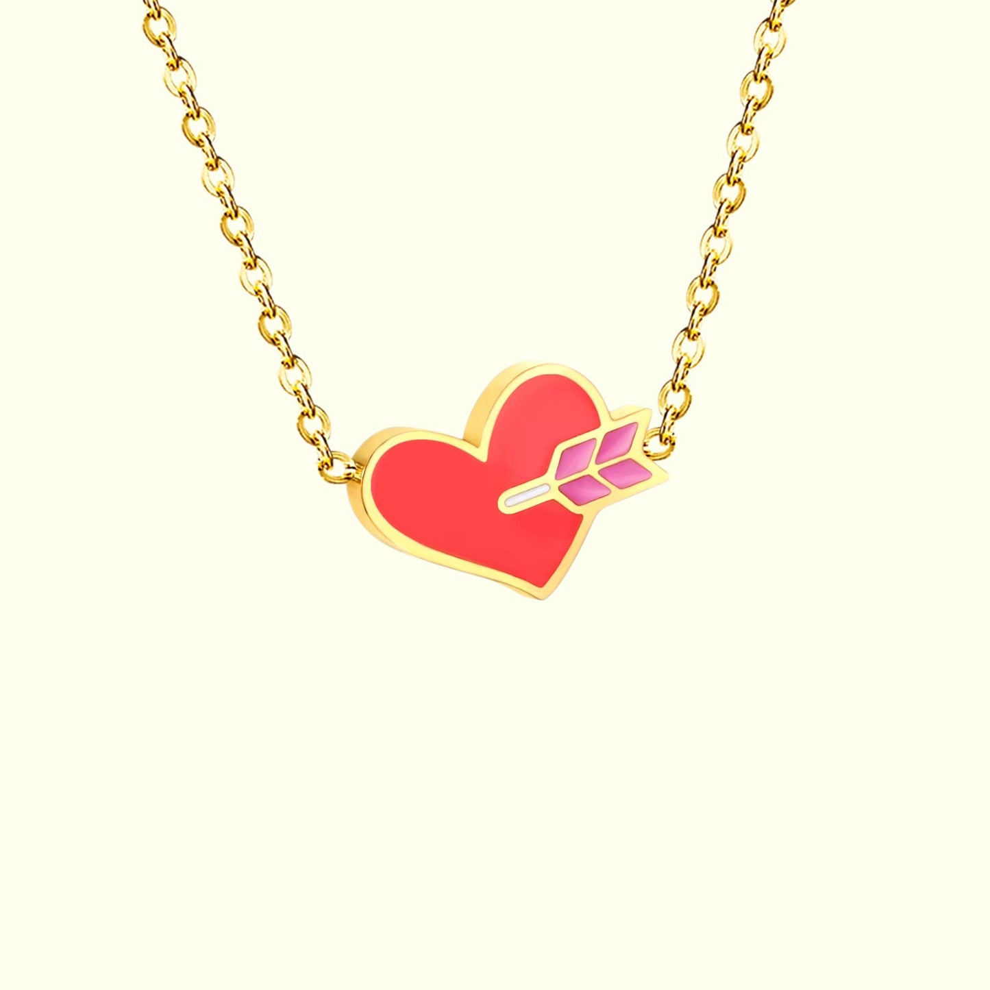Necklace with a red heart pendant and gold chain on a white background