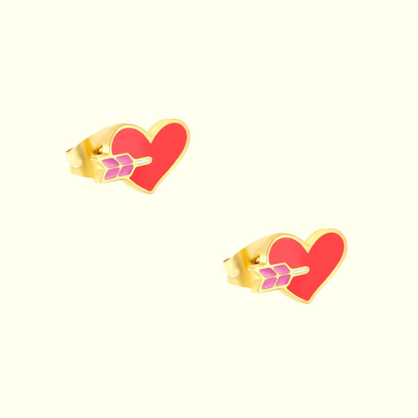 Heart-shaped earrings with gold outline and pink center on a white background