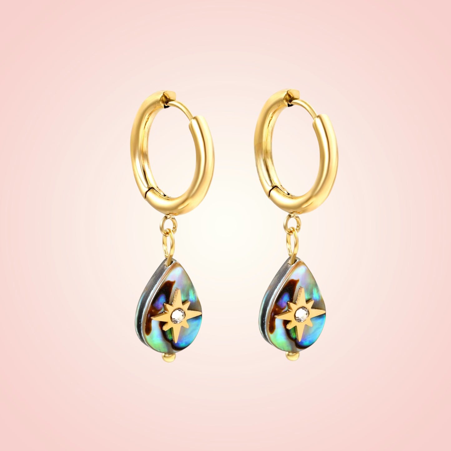 Gold hoop earrings with teardrop-shaped colorful drops on a pink background