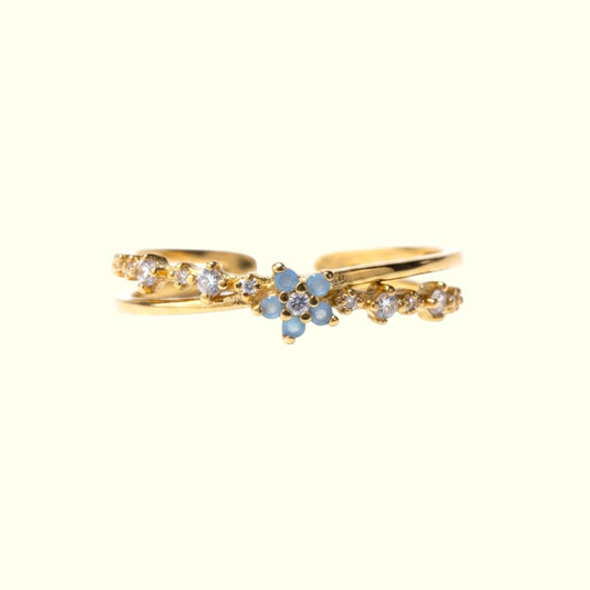 Gold ring with gemstones on a white background