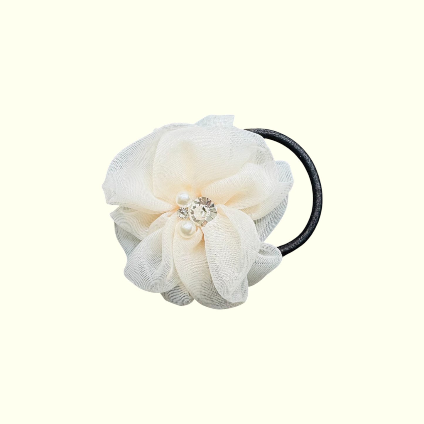 White floral hair tie with pearl embellishments on a white background