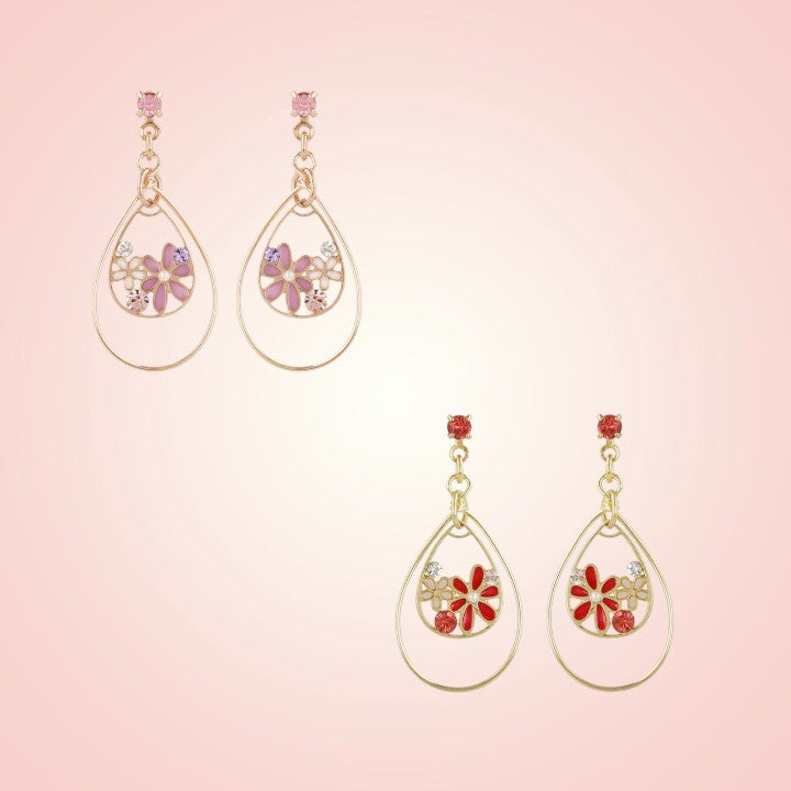 Pair of teardrop-shaped earrings with floral designs on a pink background