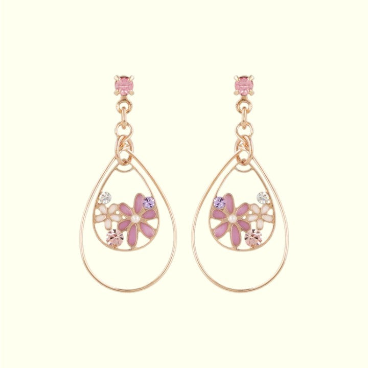 Teardrop-shaped earrings with floral designs and pink gemstones on a white background
