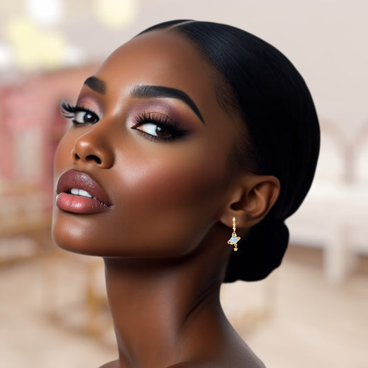 Woman with stylish hair and makeup, wearing earrings against a blurred background