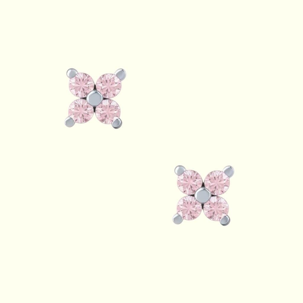 Pair of pink gemstone stud earrings on a white background