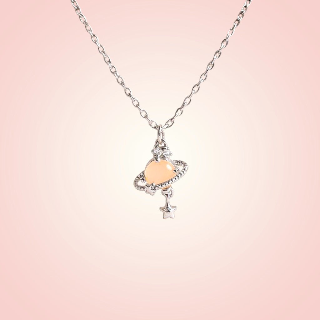 Necklace with a heart-shaped pendant on a pink background