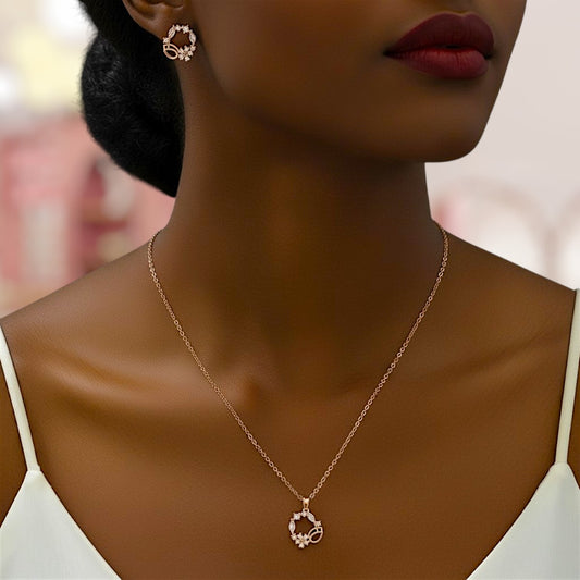 Woman wearing a gold necklace and earrings with a blurred background