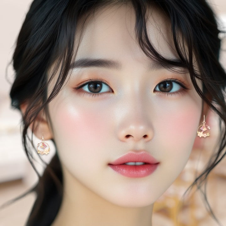 Close-up of a person wearing earrings with a blurred background