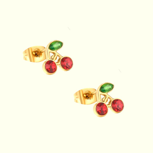 Gold cherry-shaped earrings with red and green gemstones on a white background