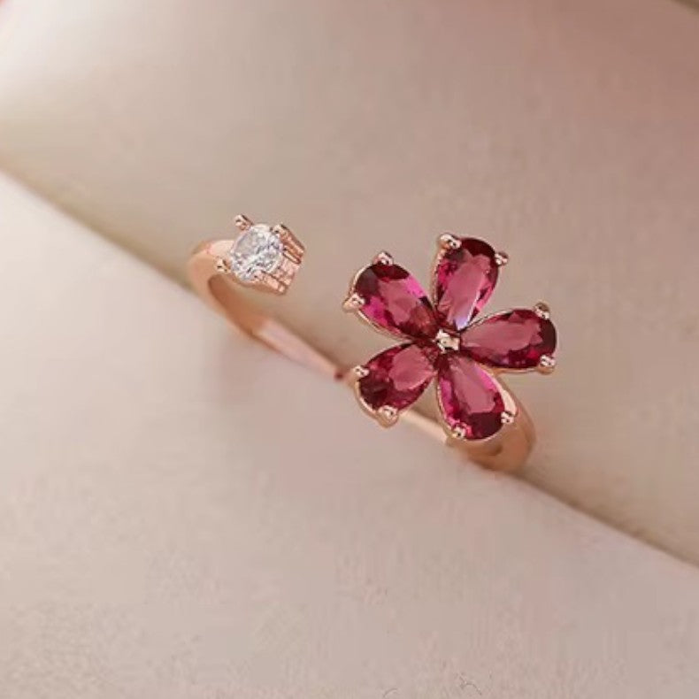 Rose gold ring with a pink gemstone on a beige background