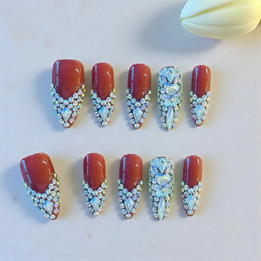Decorative nail art with gemstones on a white surface