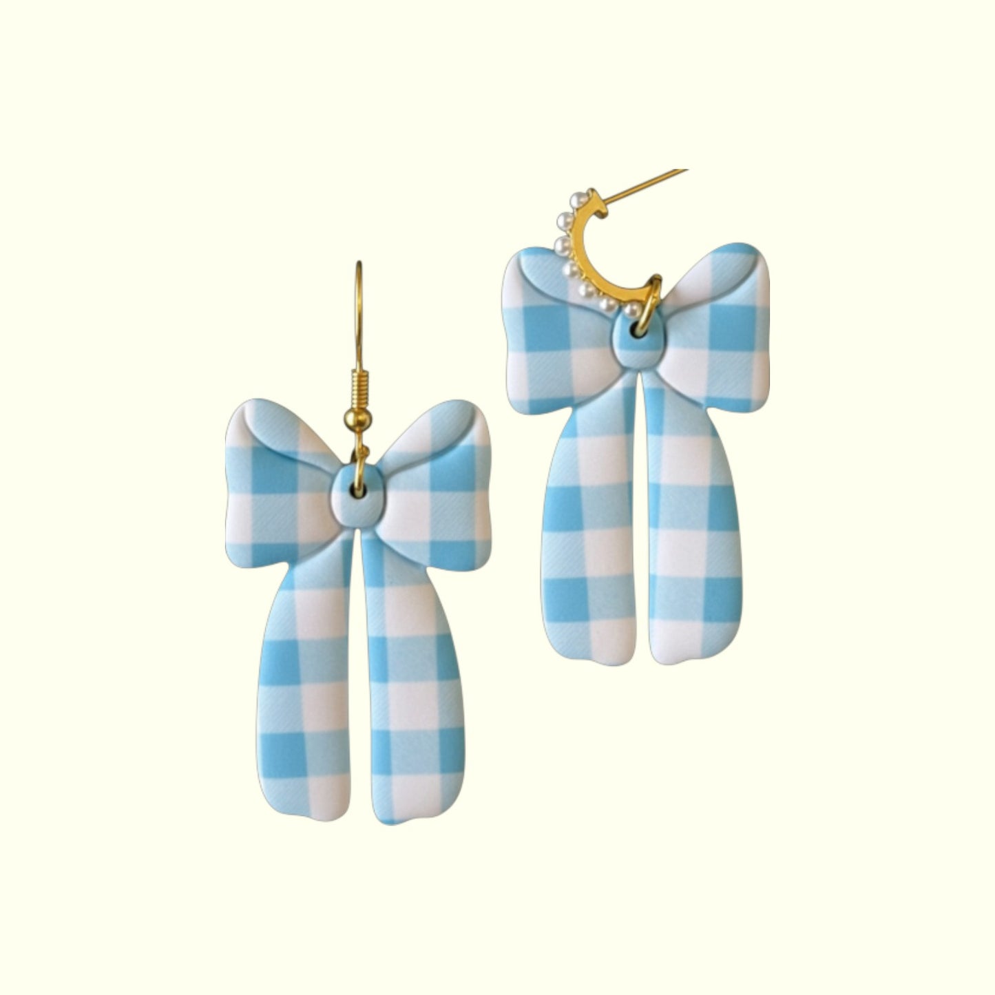 Blue and white checkered bow earrings on a white background