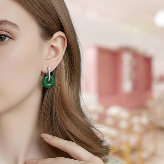 Close-up of a person wearing a green earring with a blurred background