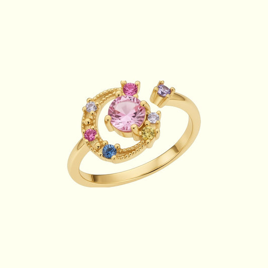 Gold ring with colorful gemstones on a white background