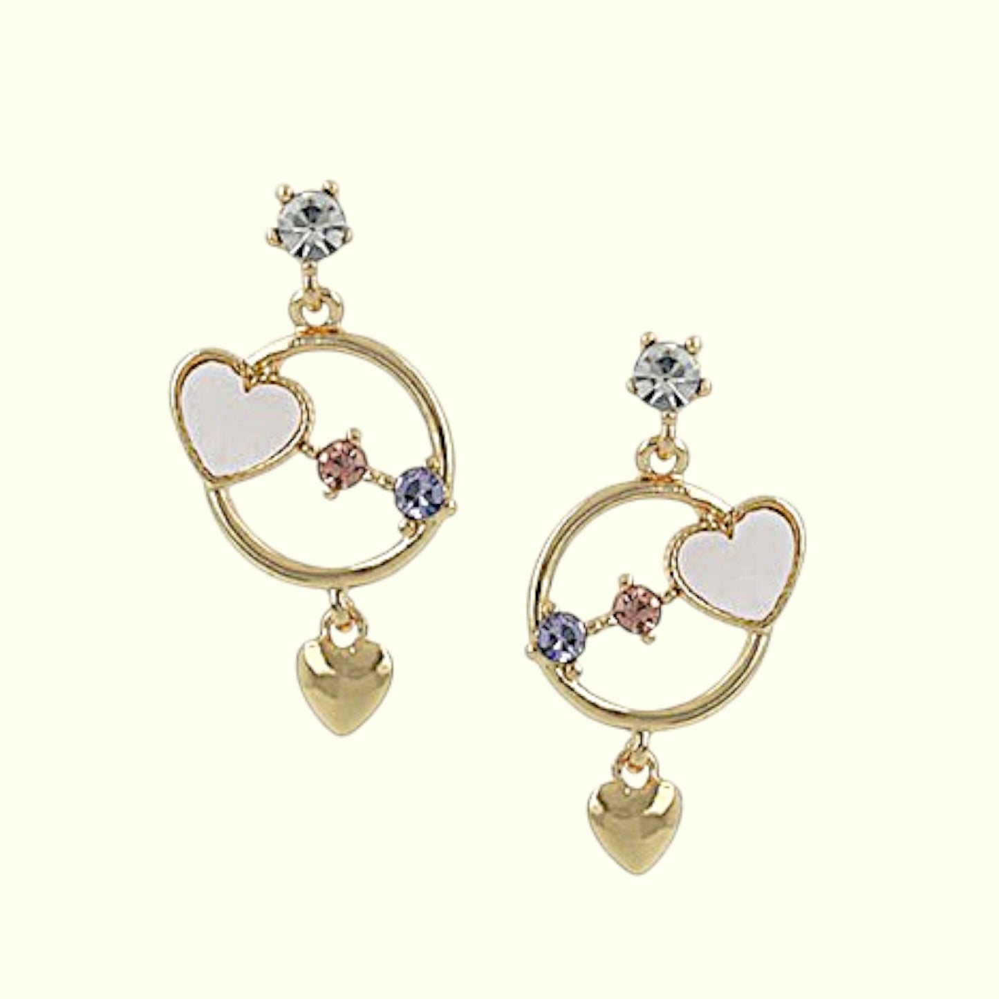 Pair of gold earrings with heart designs on a white background