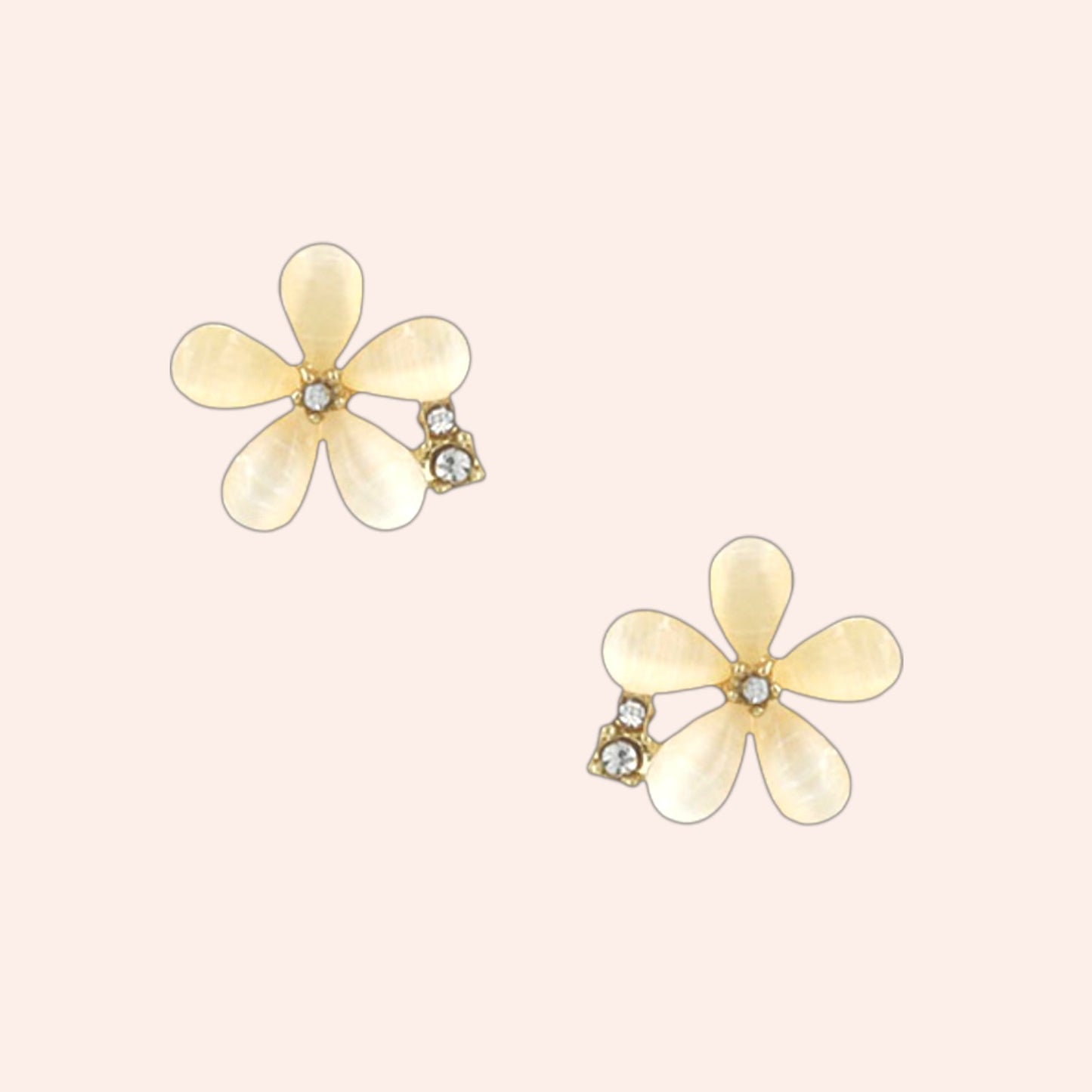 Flower-shaped earrings with gold accents on a light pink background