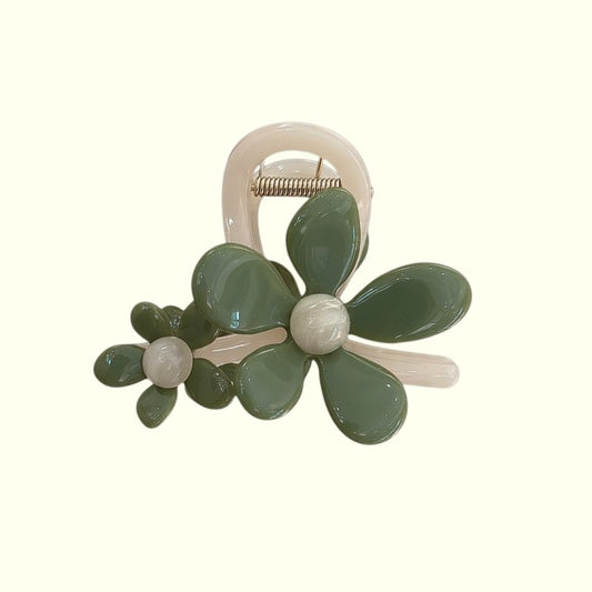Green floral hair clip on a white background