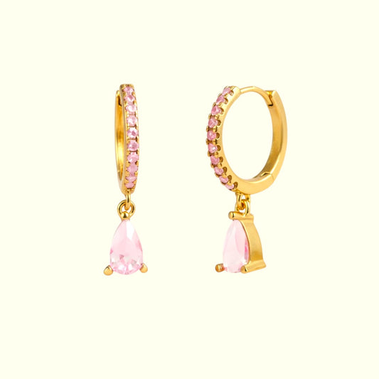 Gold hoop earrings with pink teardrop-shaped stones on a white background