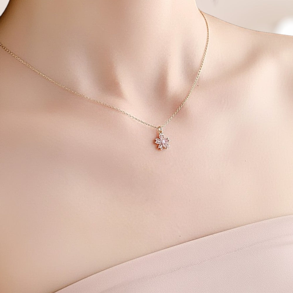 Gold necklace with a floral pendant on a mannequin