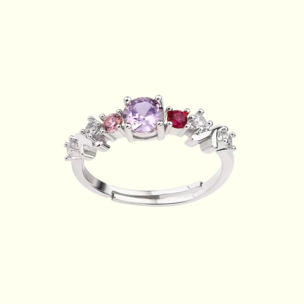 Silver ring with multicolored gemstones on a white background