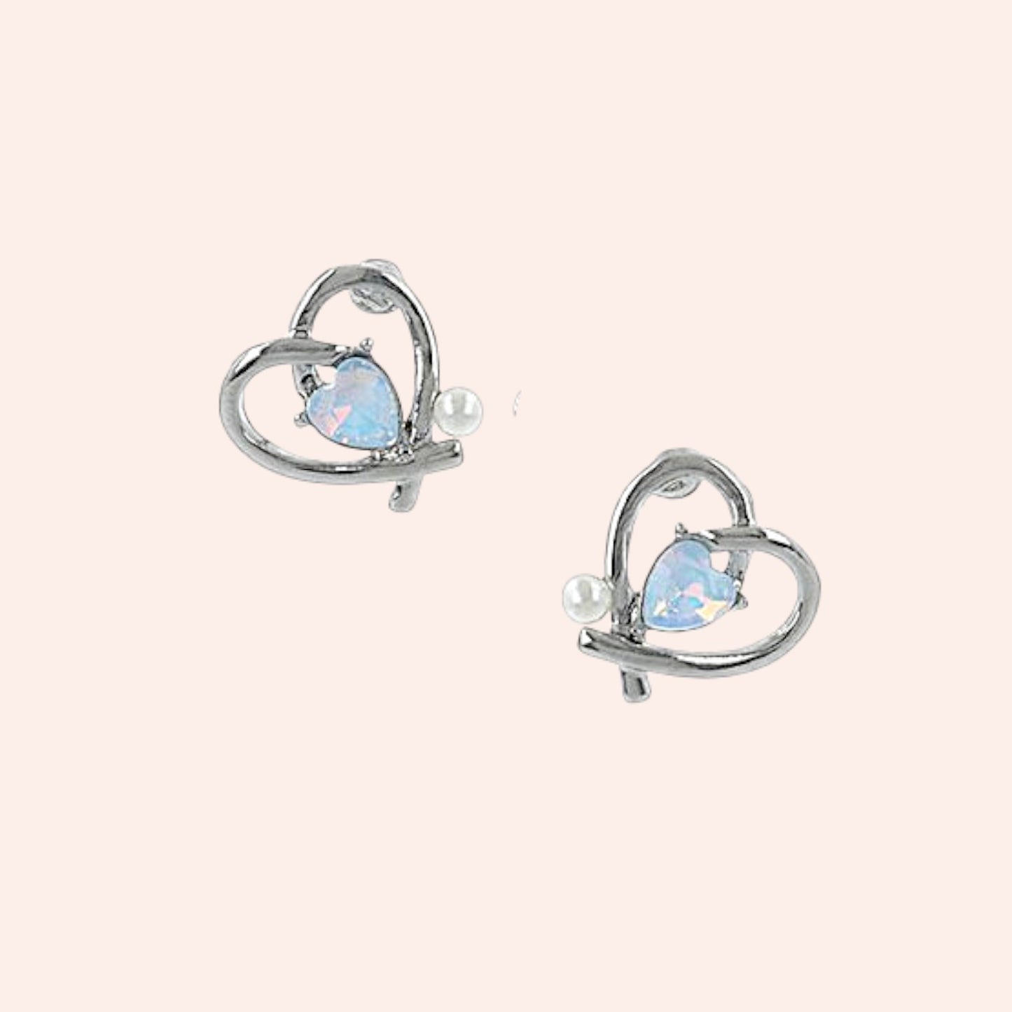 Heart-shaped earrings with blue gemstones and pearls on a white background