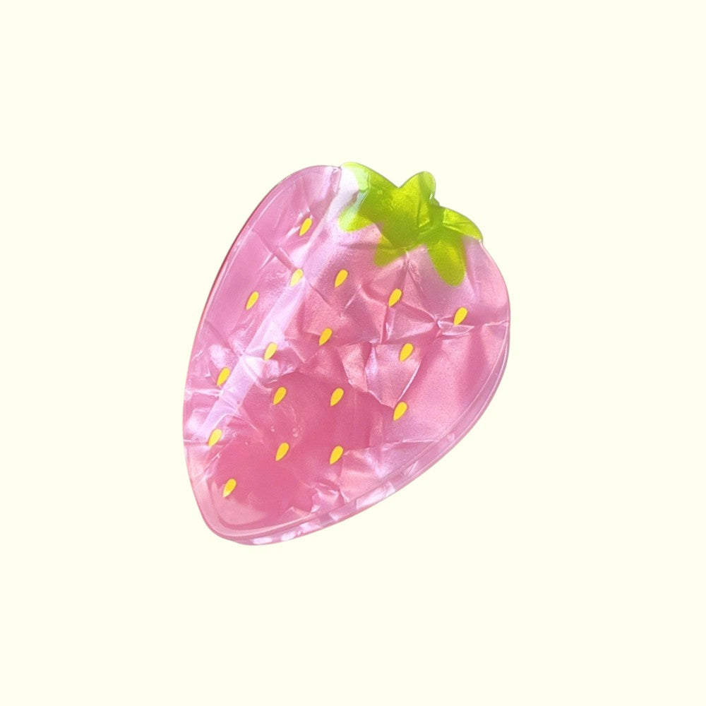 Inflatable strawberry pool float on a white background