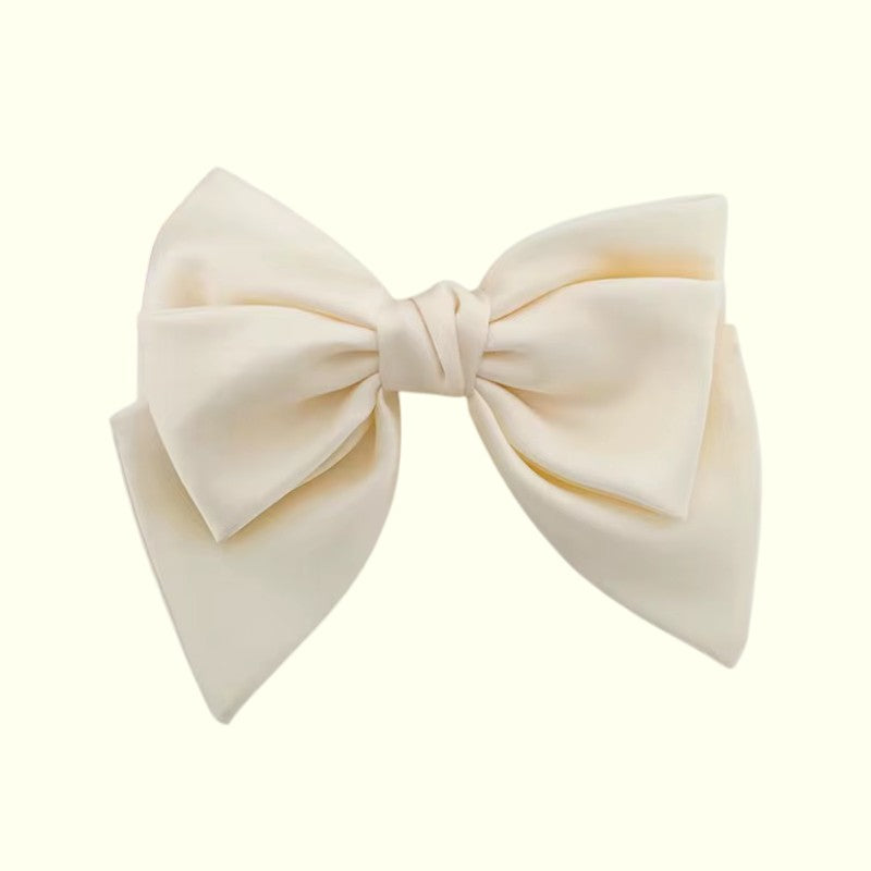 Large cream-colored bow on a white background