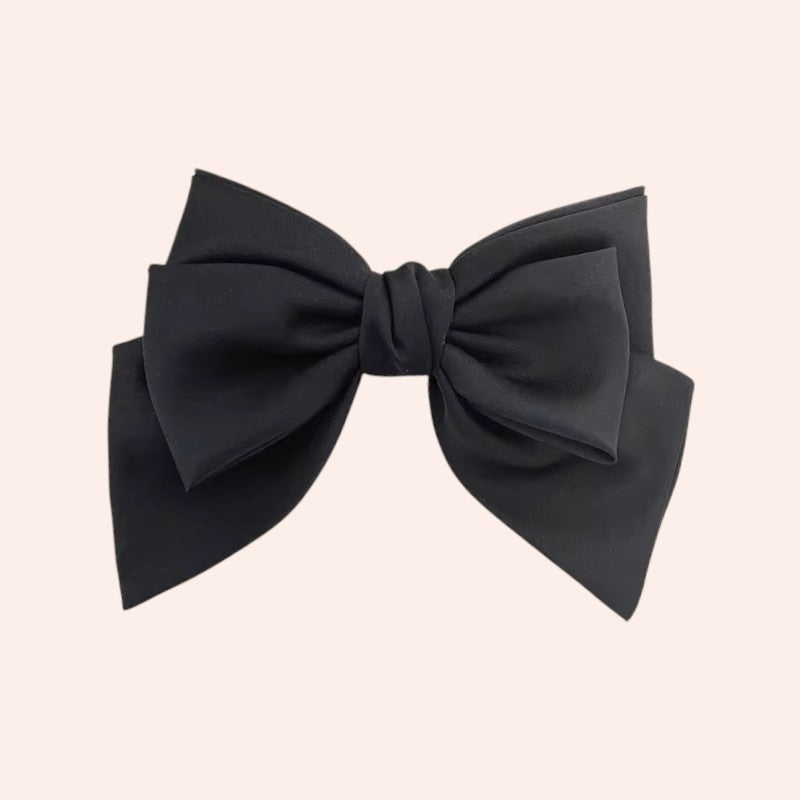 Black bow on a beige background
