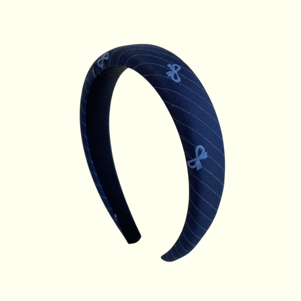Navy blue headband with light blue pattern on a white background