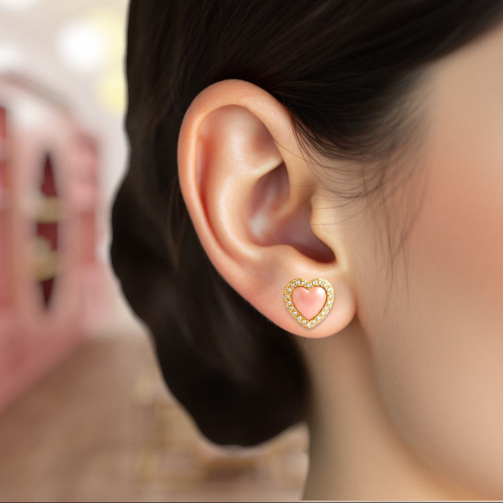 Heart-shaped earring worn by a person with a blurred background