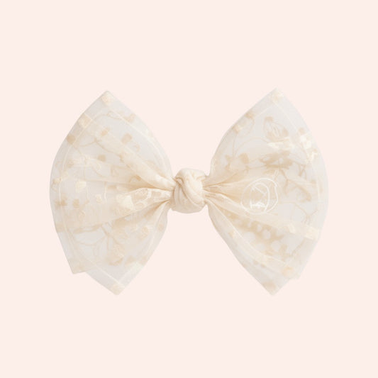 Bow-shaped hair accessory with a marble pattern on a white background
