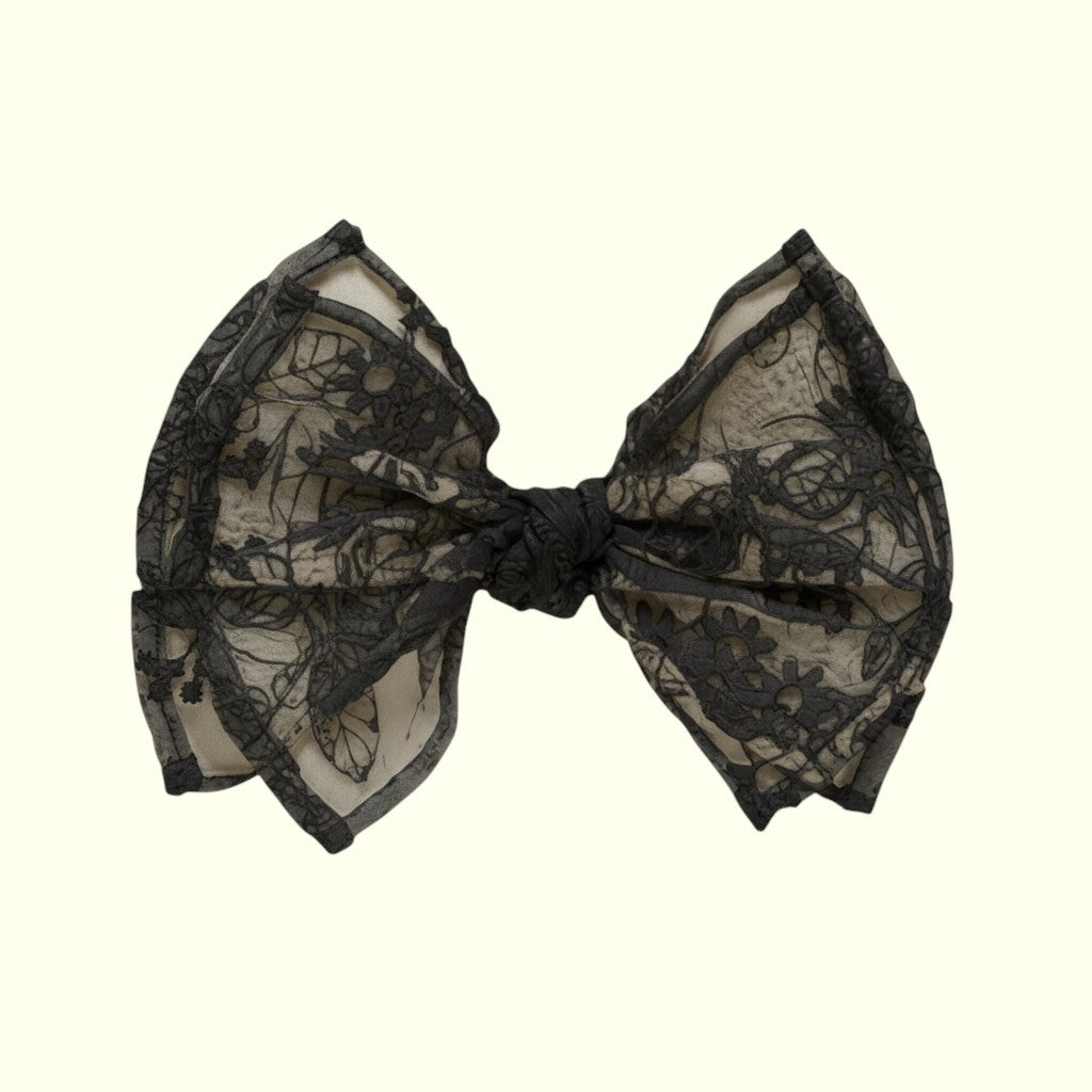 Black lace bow on a white background