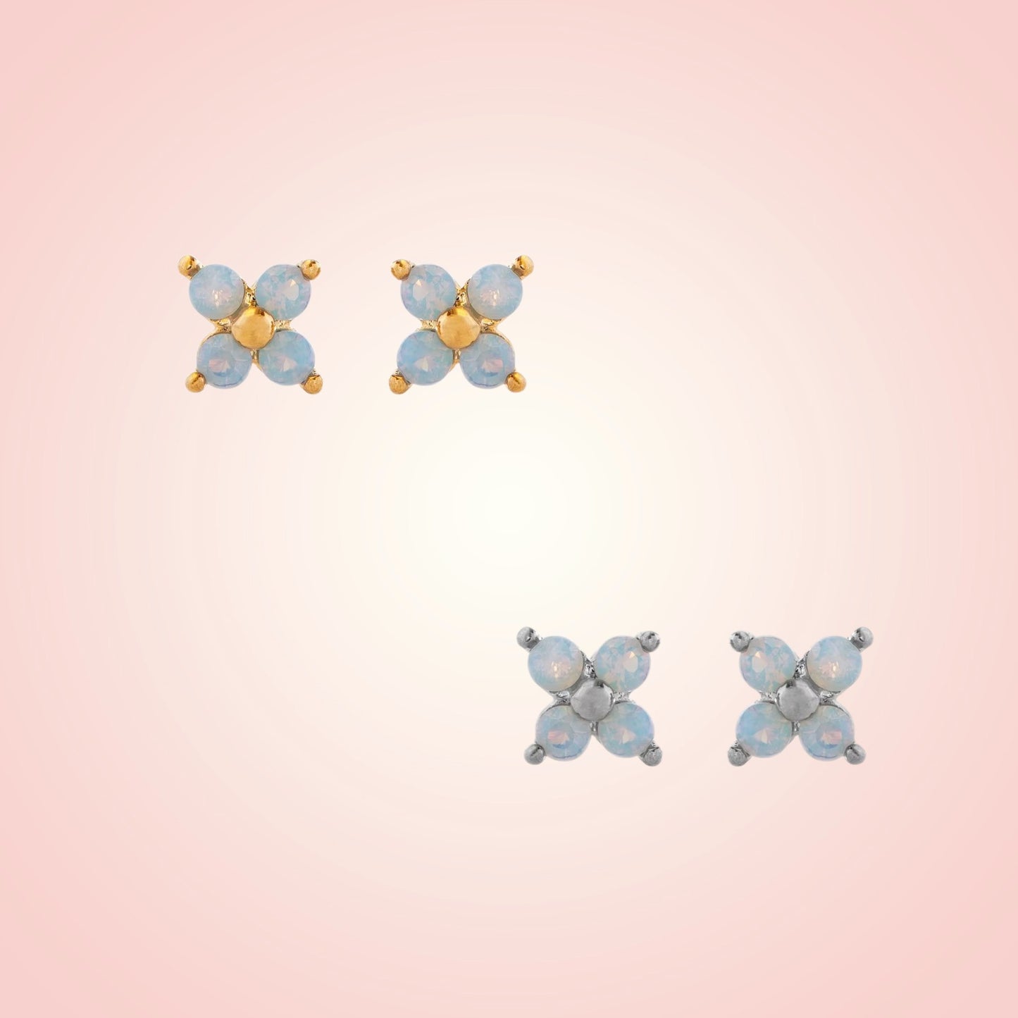 Pair of butterfly-shaped earrings on a gradient pink background