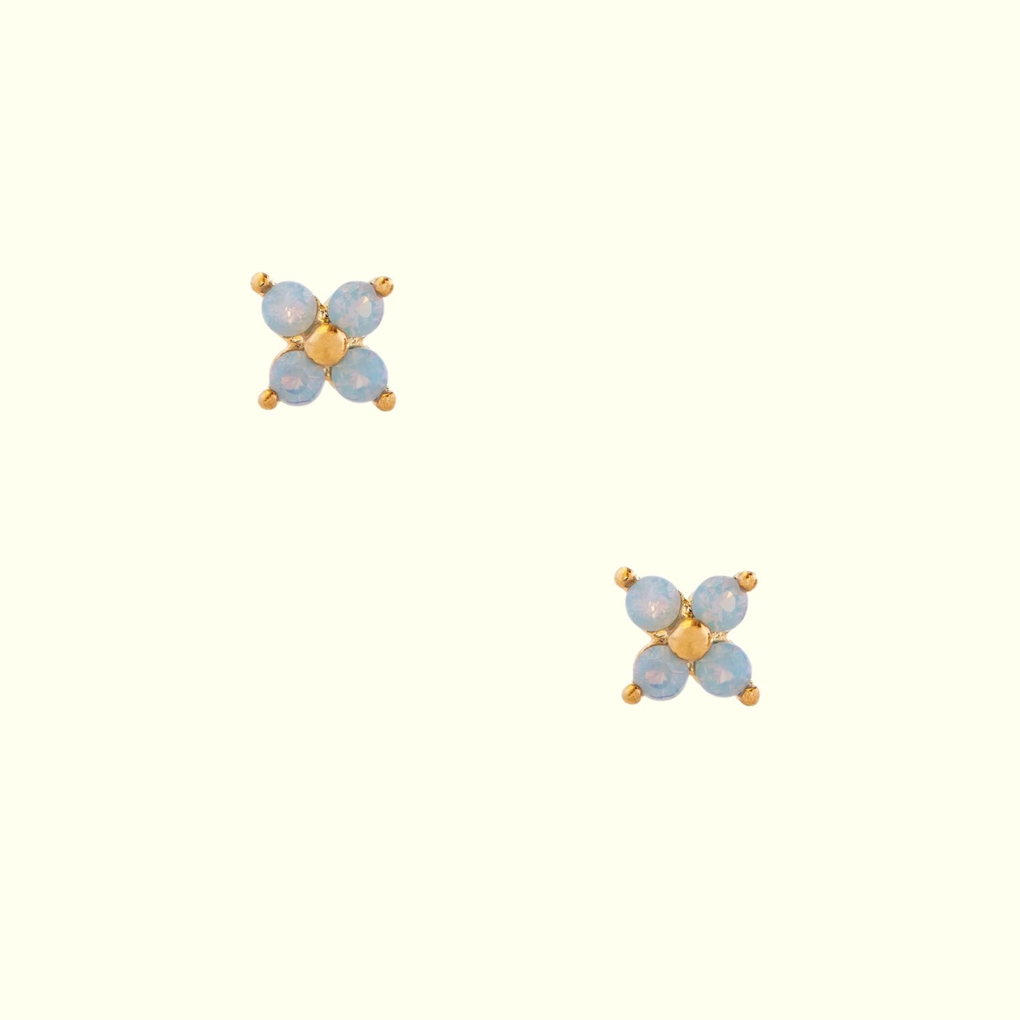 Pair of gold and blue earrings on a white background