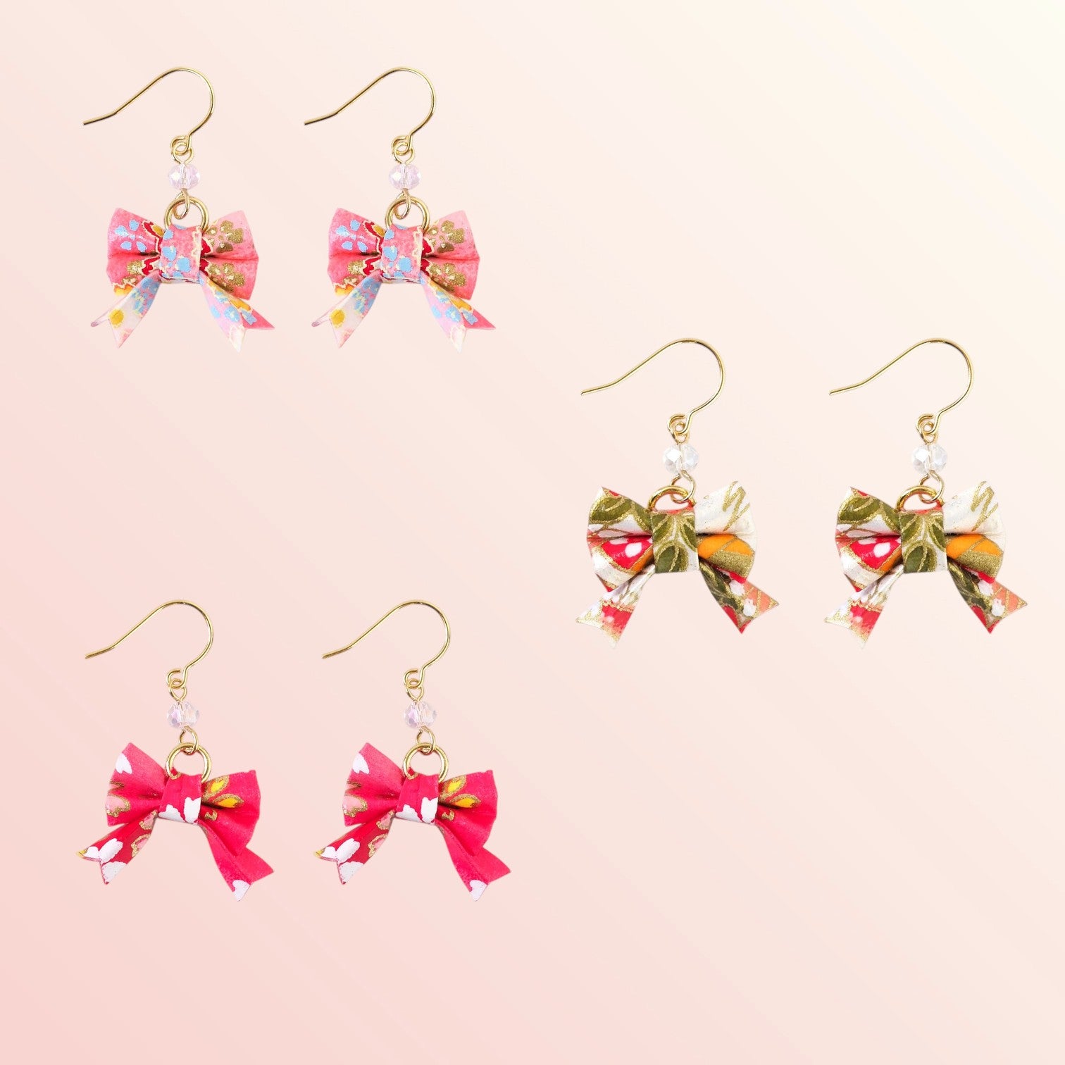 Set of colorful bow-shaped earrings on a pink background