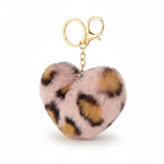 A heart-shaped faux fur keychain with a pink, brown, and black leopard print pattern, attached to a gold-tone metal clasp on a white background.