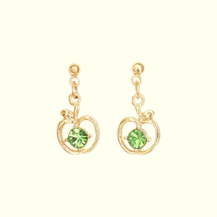 Gold earrings with green gemstones on a white background