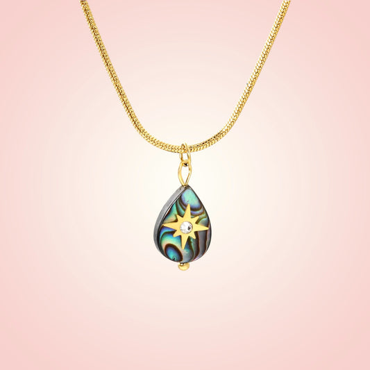 Necklace with a teardrop-shaped pendant on a pink background