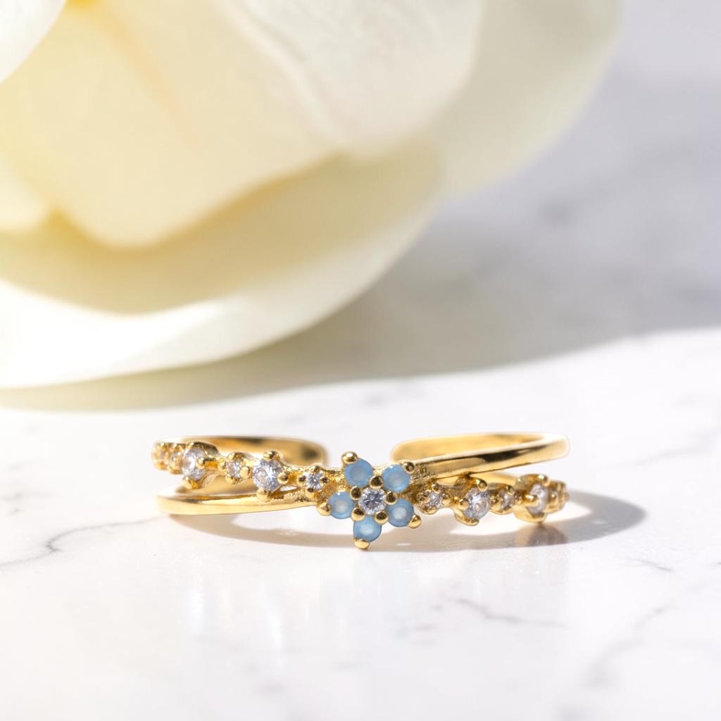 Gold rings with gemstones on a light background