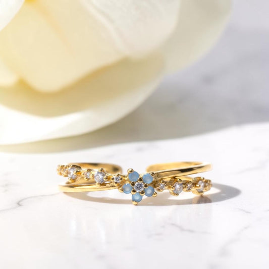 Gold rings with gemstones on a light background