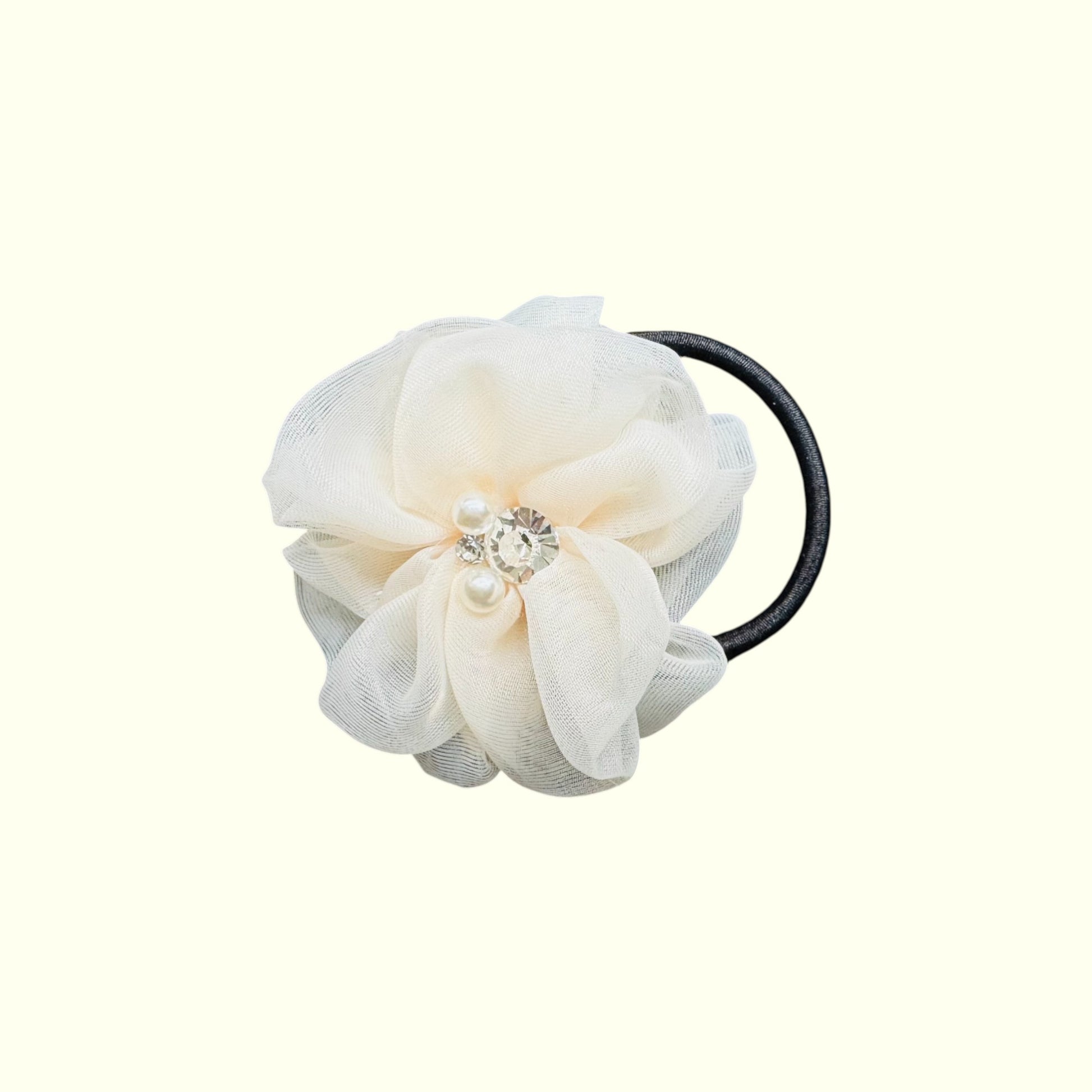 White floral hair tie with pearl embellishments on a white background
