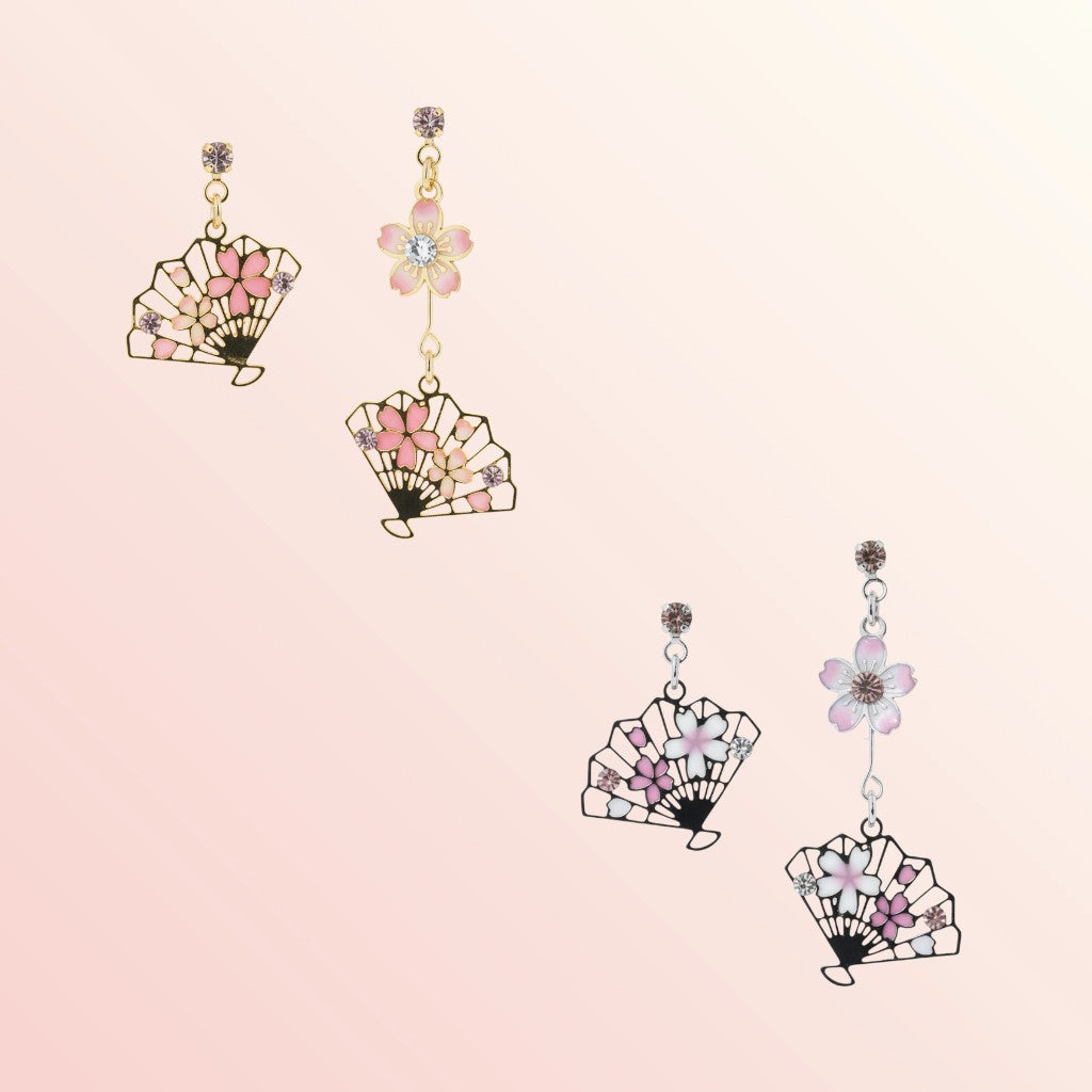 Fan-shaped earrings with floral details on a light pink background