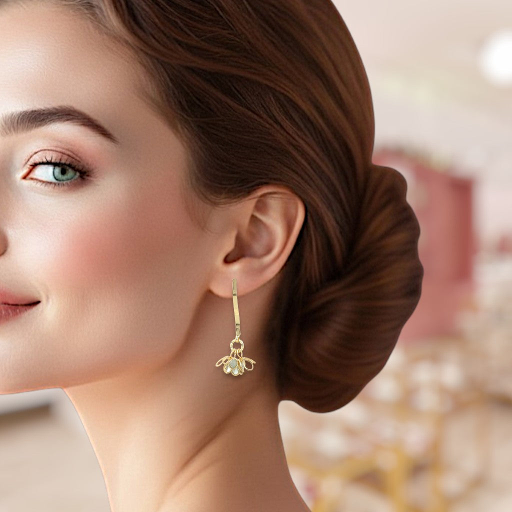 Close-up of a woman wearing a gold earring with a blurred background