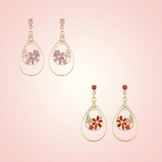 Pair of teardrop-shaped earrings with floral designs on a pink background