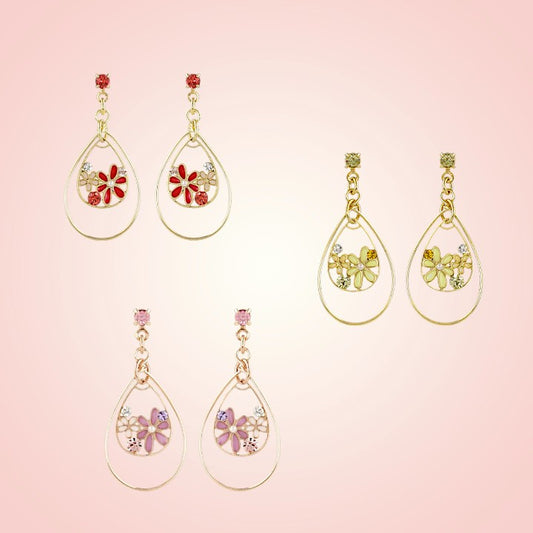 Set of four pairs of earrings with floral designs on a pink background