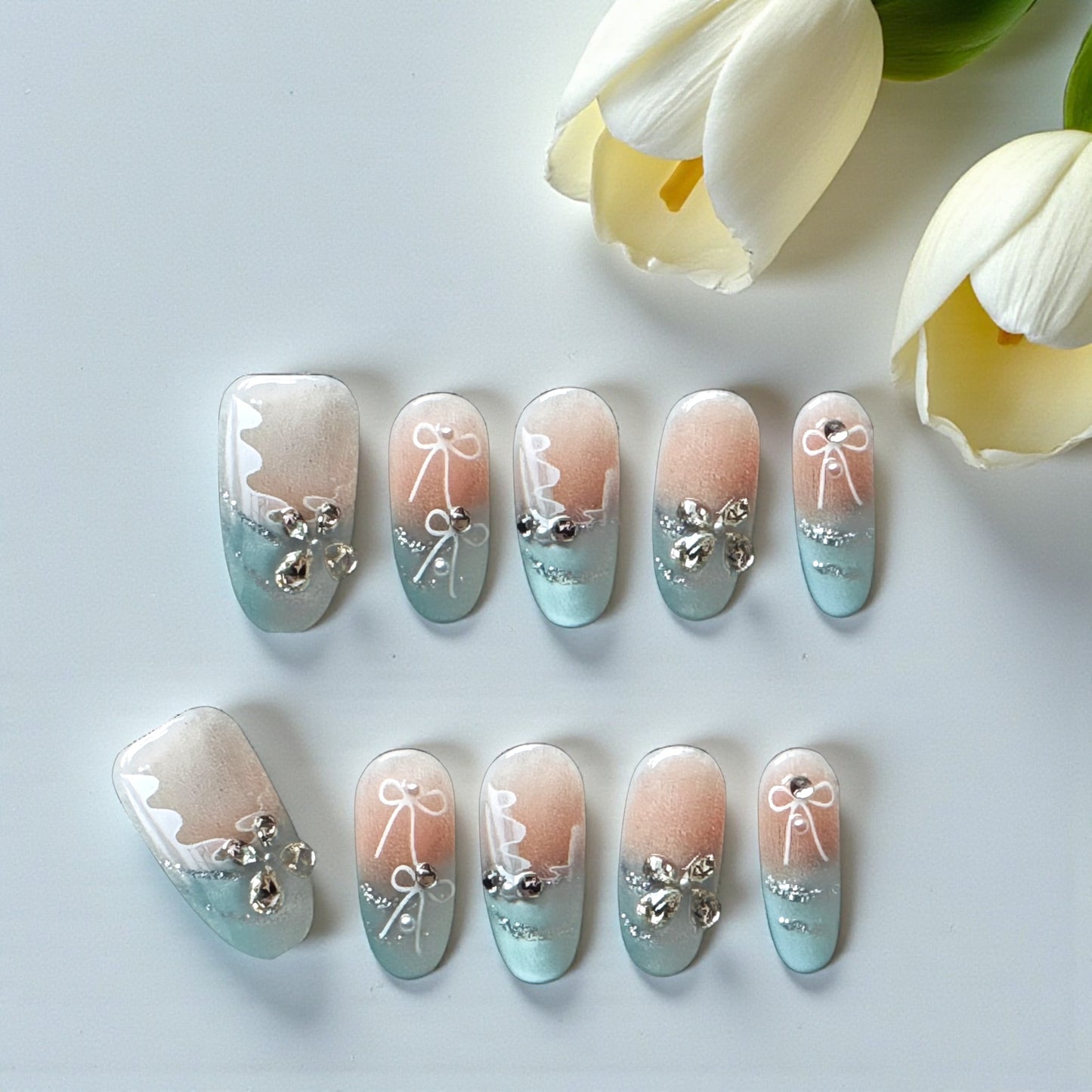 Nail art with decorative elements on a light background with flowers