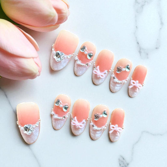 Decorative nail art with pink and white design on a marble background