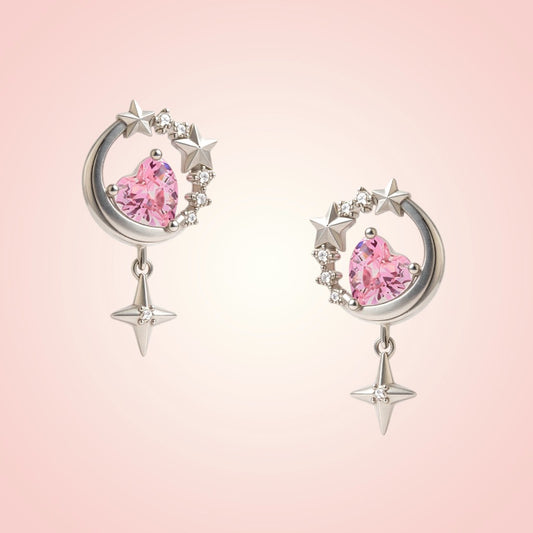 Pair of earrings with pink gemstones and silver accents on a pink background