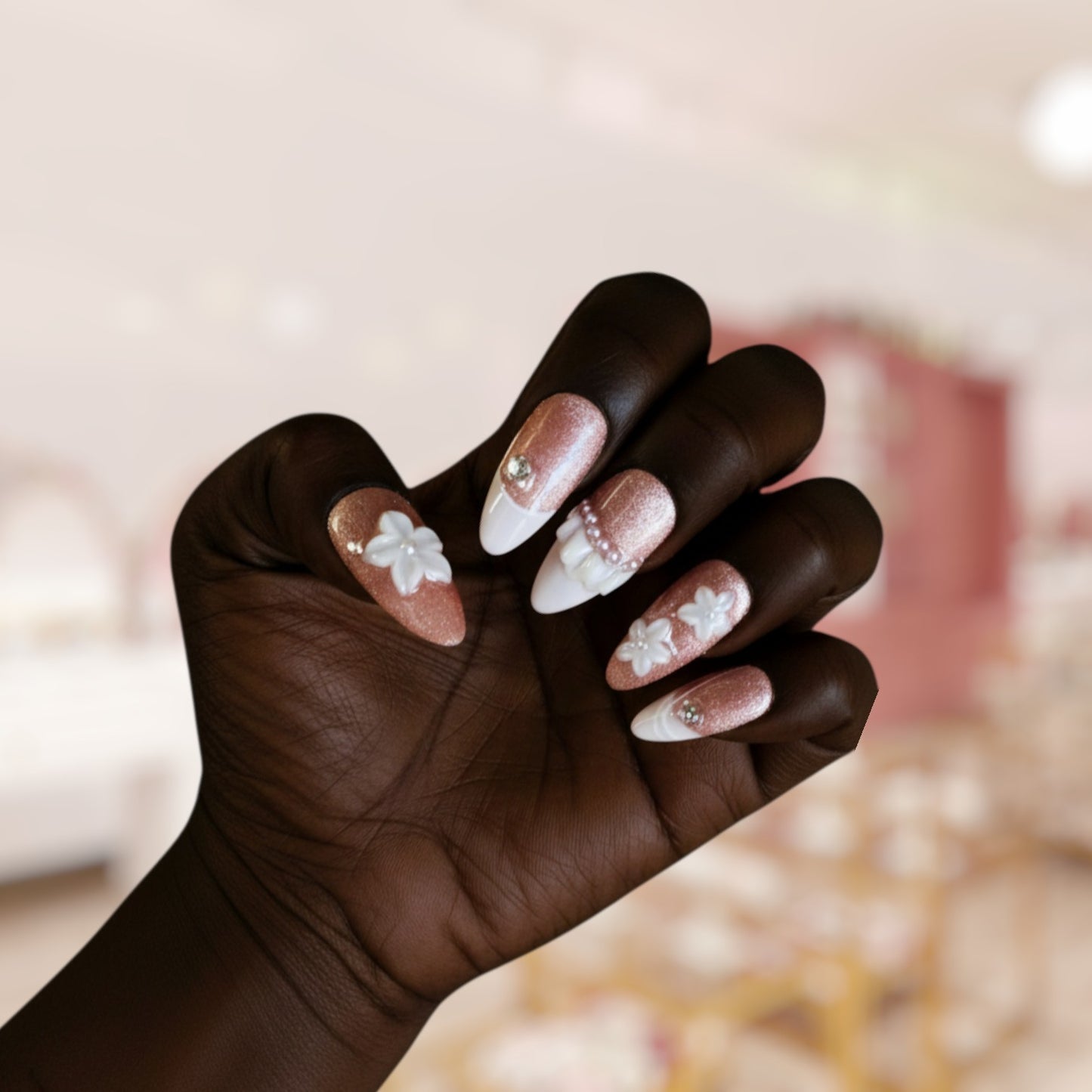 Hand with decorative nails against a blurred background