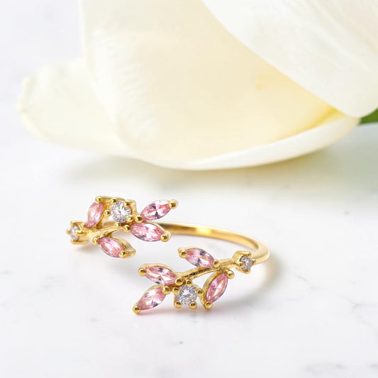 Gold and pink gemstone bracelet on a white background